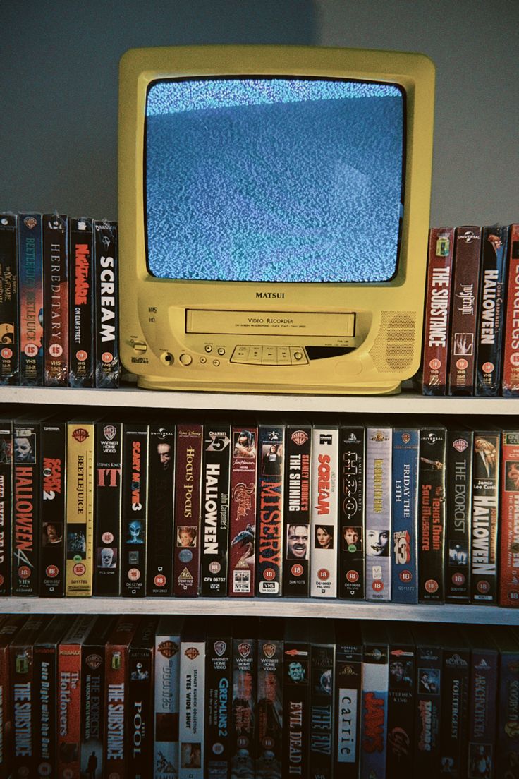 A group of VHS tapes displayed on a shelf